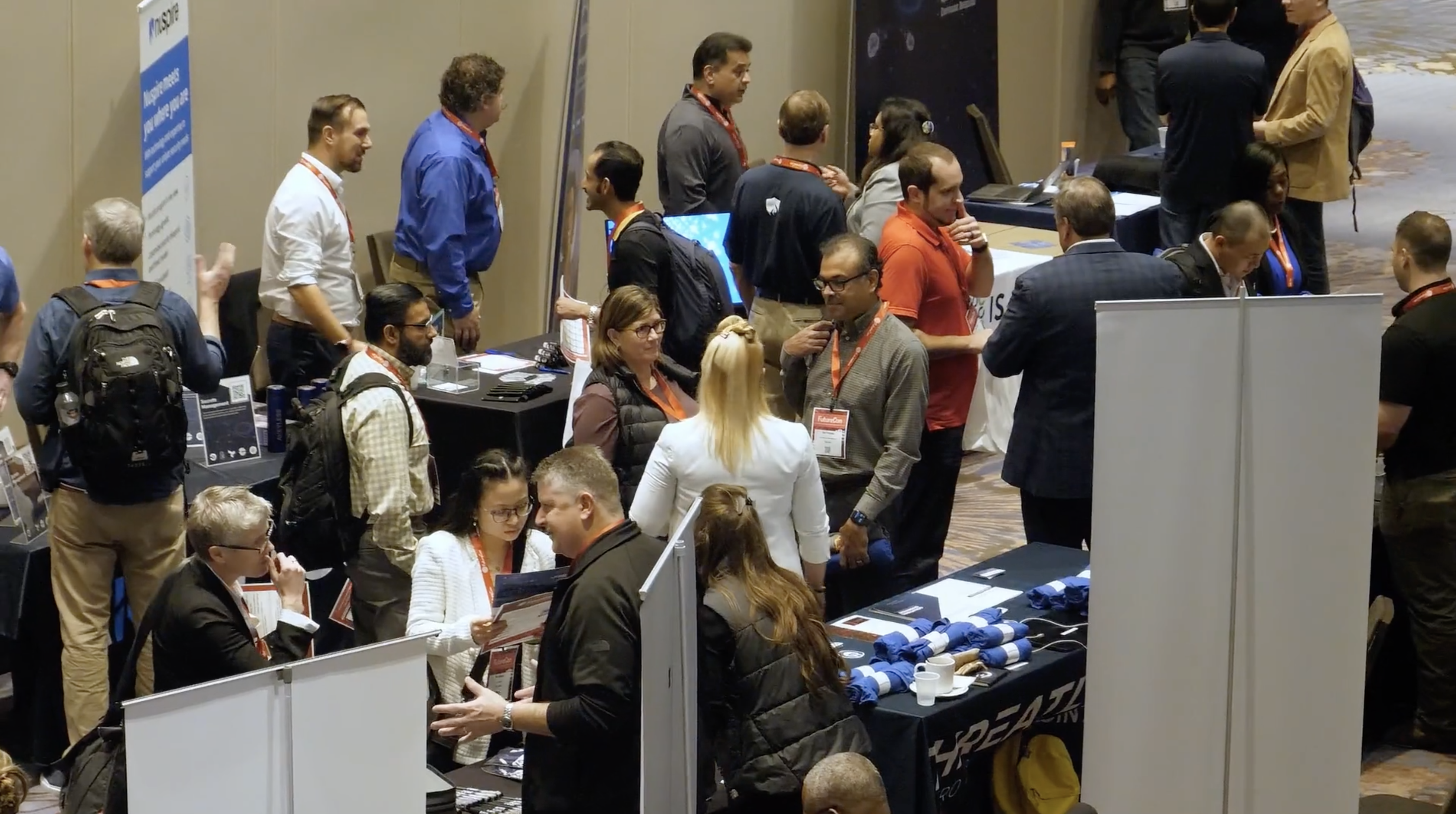 Photo of people mingling at a conference.